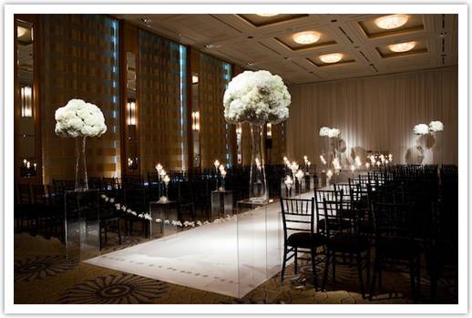 The dramatic use of drapes and flower arrangements transformed this space