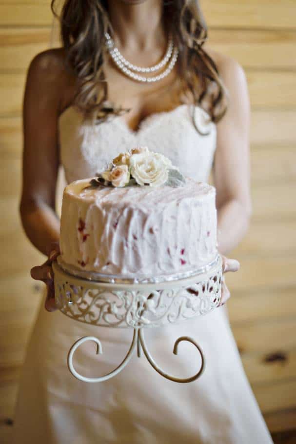 Bride holding real satellite cake by Andie Freeman Photography