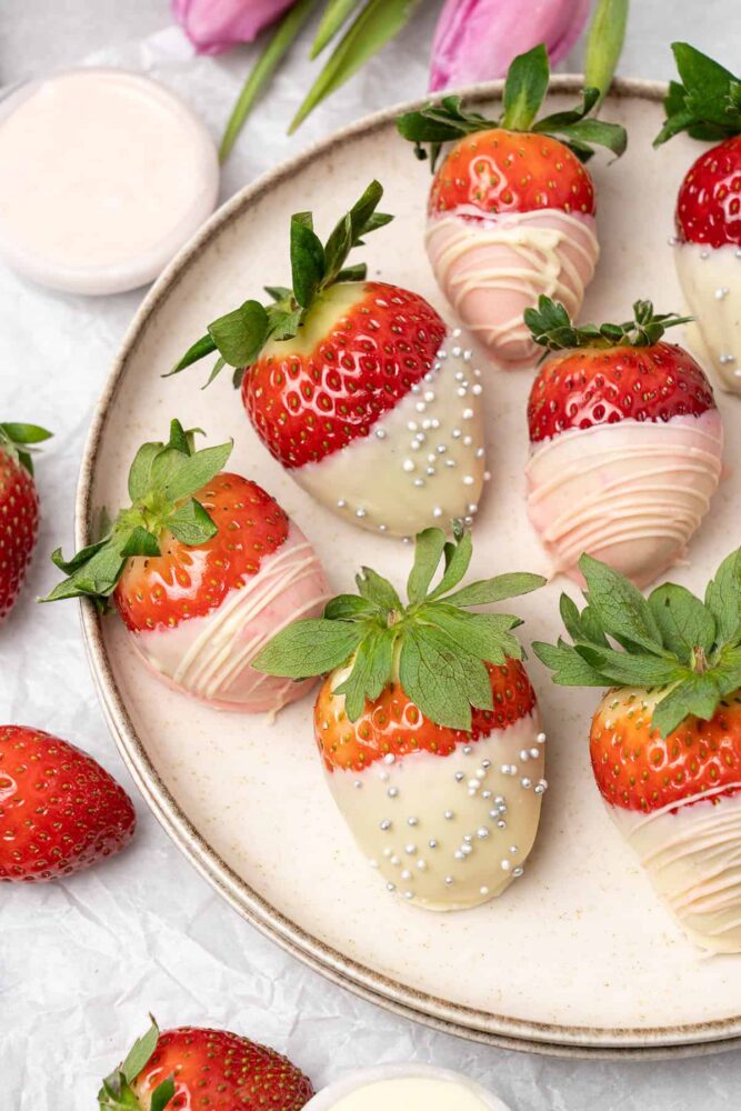 white chocolate covered strawberries on a plate.