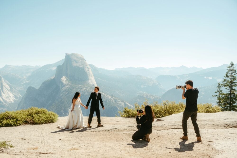 Photographer capturing couple with mountain backdrop
