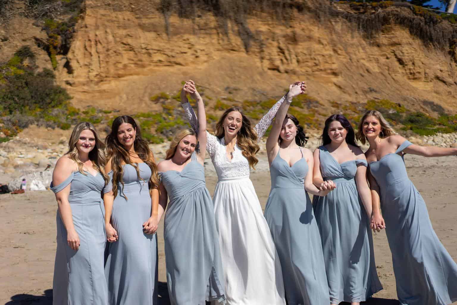 six women in white dresses standing on brown rock formation during daytime