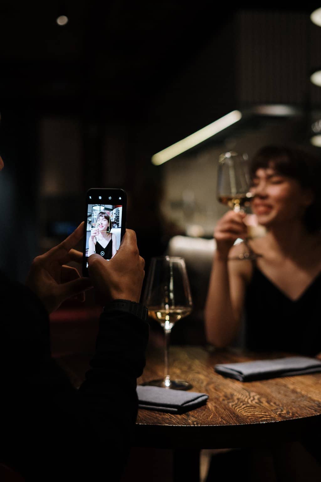 Free Woman in Black Long Sleeve Shirt Holding Smartphone Stock Photo