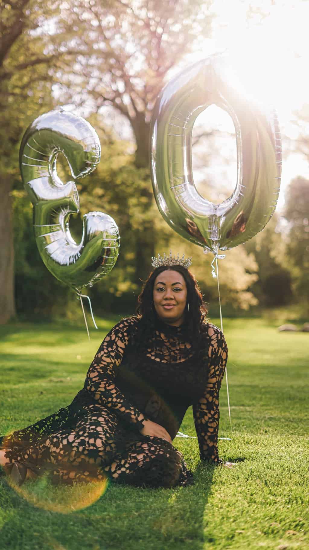 Free Black woman with balloons in shape of number 30 Stock Photo