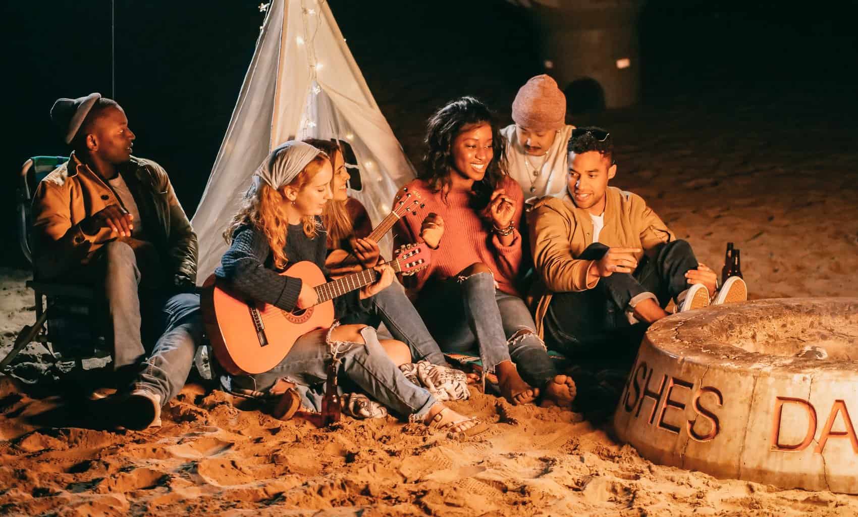 Free Group of Friends Sitting on Beach Sand Stock Photo