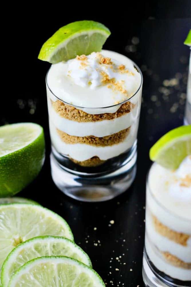 Key lime pie turned into a mini dessert! Layer traditional pie fillings in shooter glasses for key lime pie shots; the perfect no-bake party dessert!