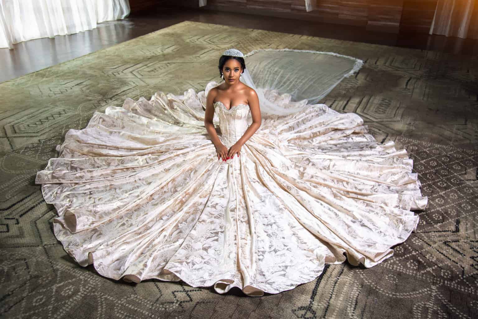 A woman in a wedding dress sittig down.