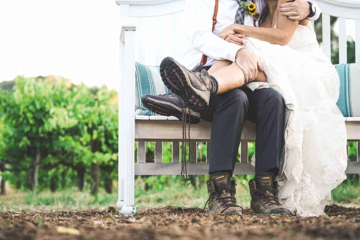 Bride wearing a traditional white wedding dress and combat boots