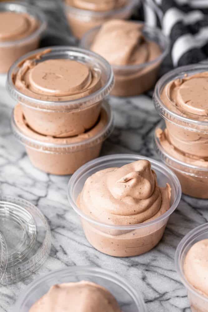 pudding shot in plastic condiment cups on a marble slab