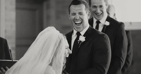 Couple laughing at their own wedding vows