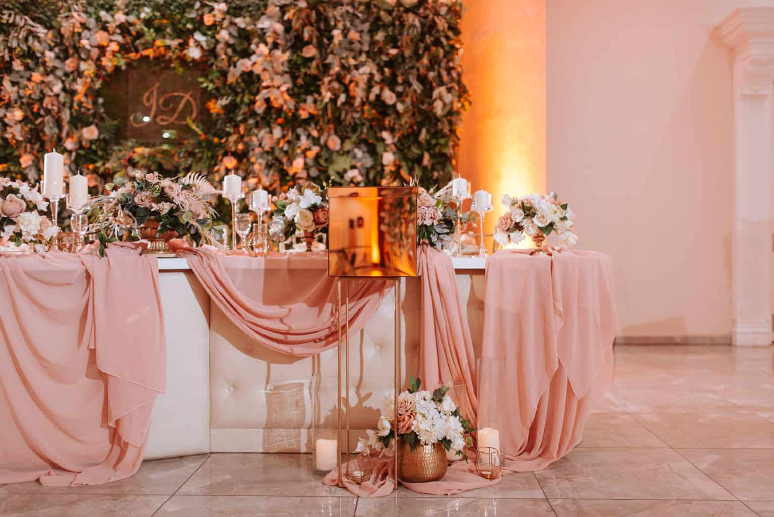 Rose gold wedding decor against beige walls