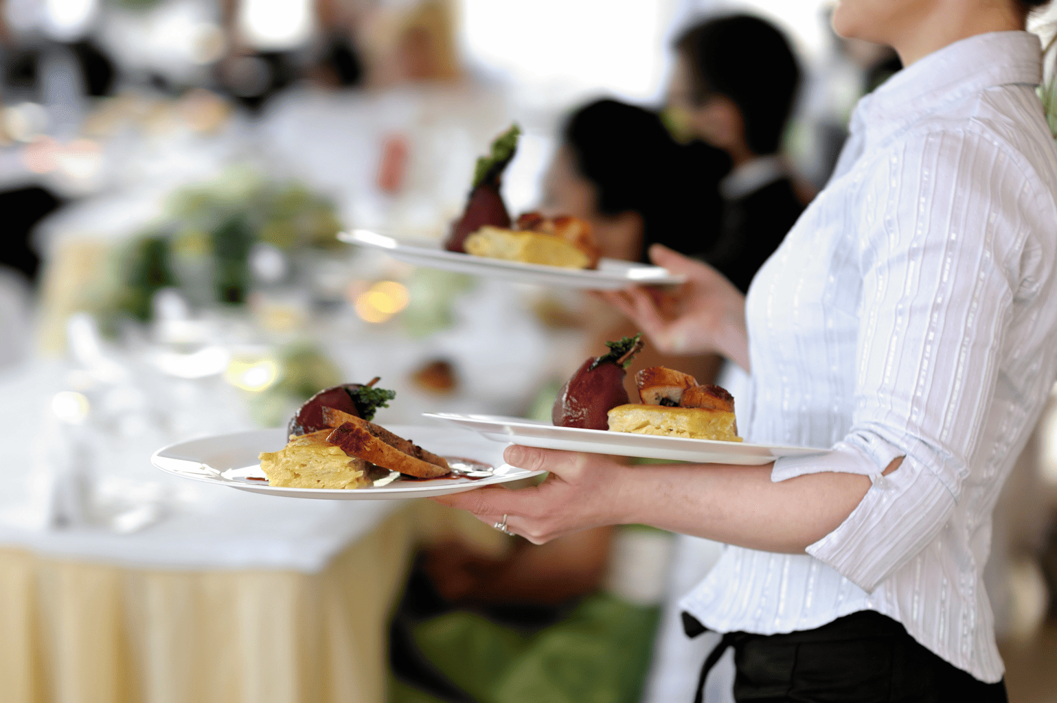 Waitress carrying plates at a restaurant