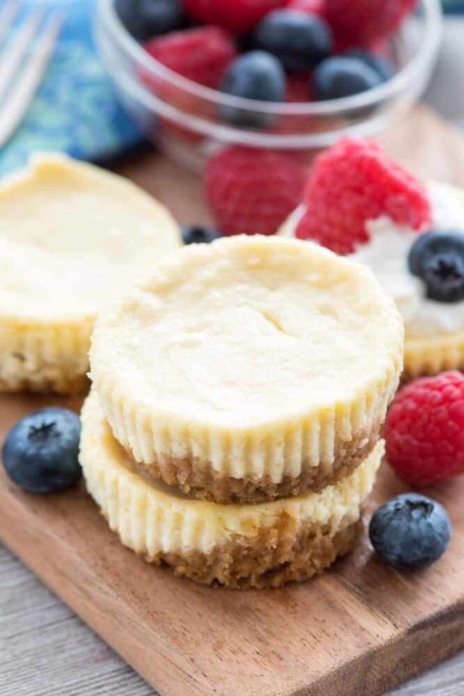 Easy Mini Cheesecake Recipe - this simple cheesecake recipe makes 12 perfect mini cheesecakes and can be made so many ways! Lemon, Oreo, S'mores, Fruit, Peanut Butter Cup - any cheesecake you want in no time at all.