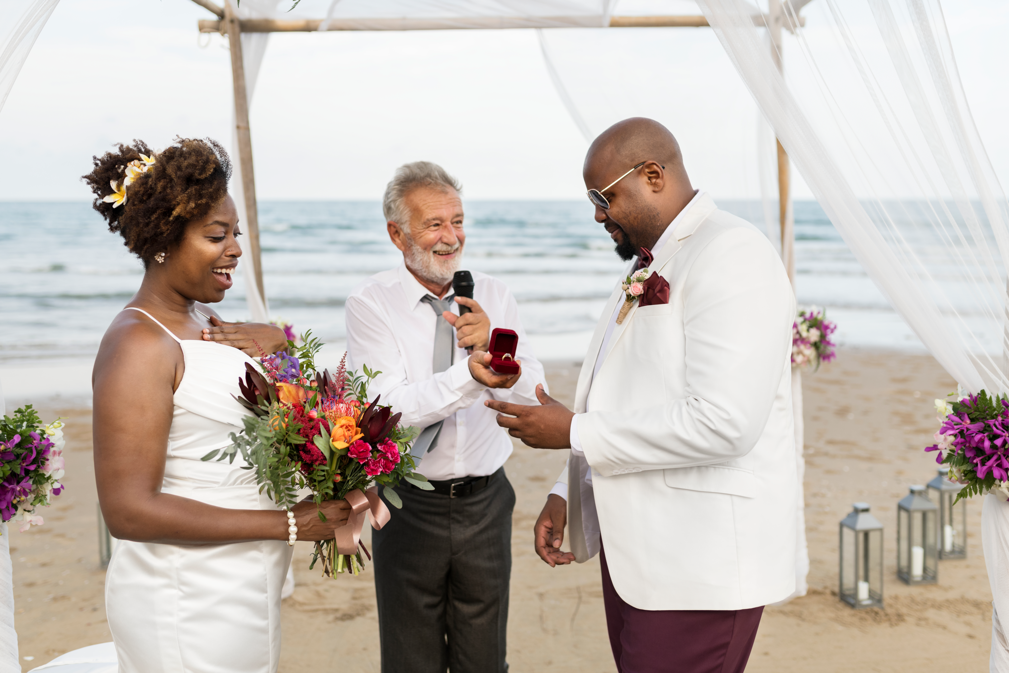 Couple laughing with marriage officiant