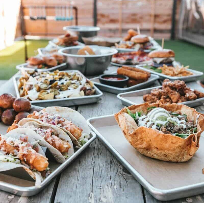 How to plan a potluck wedding - selective photography of plates of food on table during daytime - Spencer Davis Photography