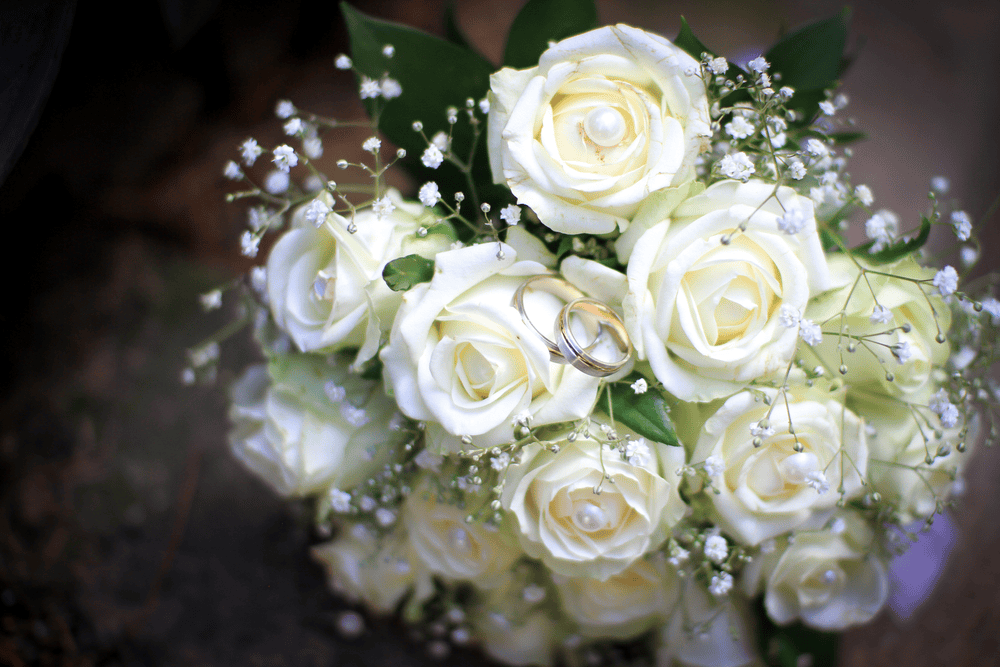 Wedding rings attached to wedding flowers
