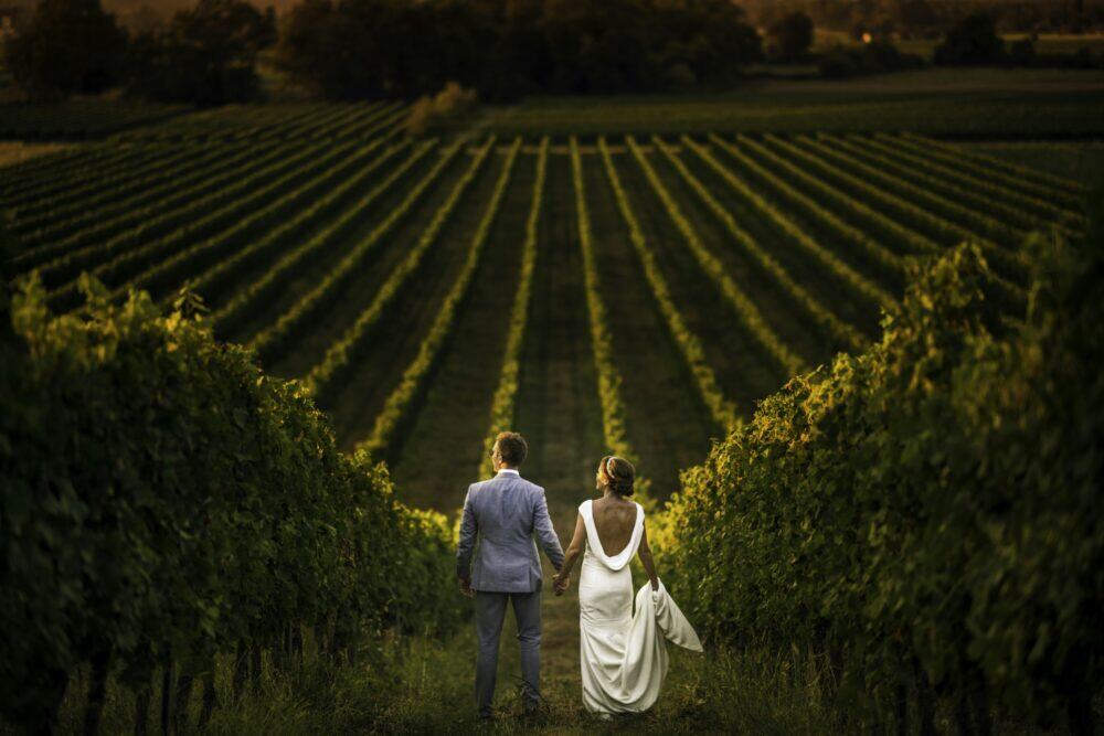 man and woman walking on green grass field during daytime