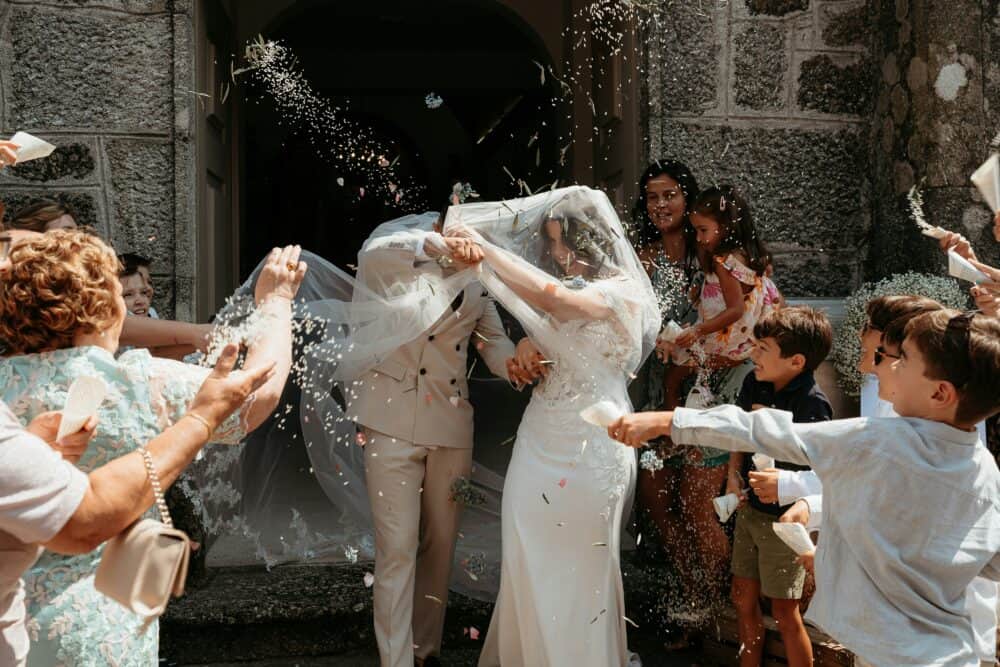 Newlyweds showered with confetti leaving church