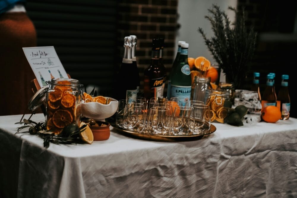 a table topped with lots of bottles and glasses