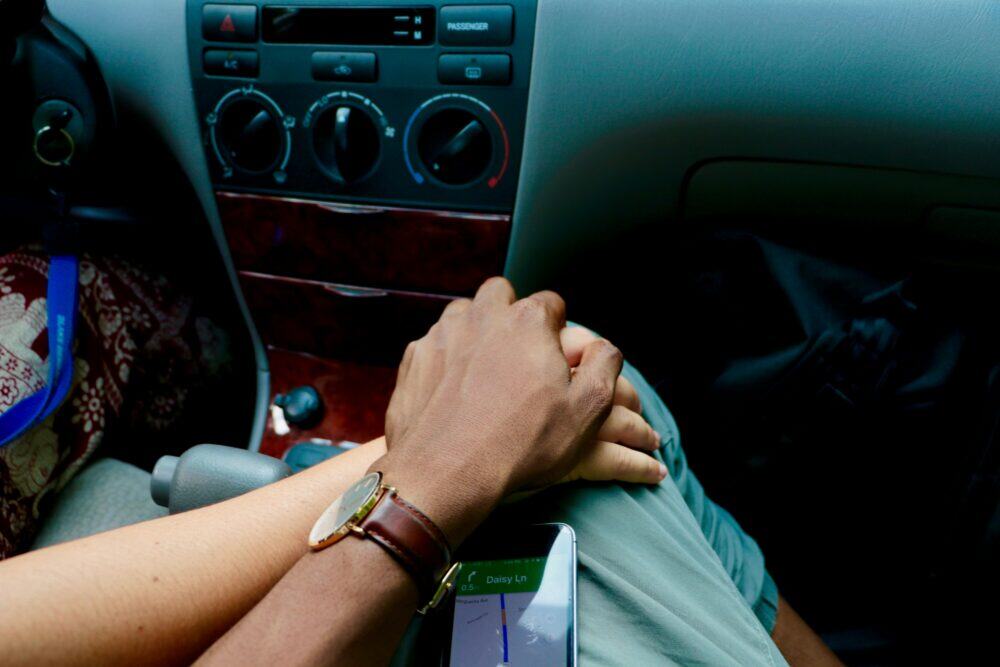 31 Fun Car Trip Games for Couples (Keep the Laughs Going All the Way!) 7 person wearing gold bracelet and white shirt