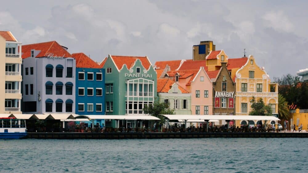 Choosing a Small Wedding Destination - What Makes a Venue “Small”? 10 A row of colorful buildings next to a body of water