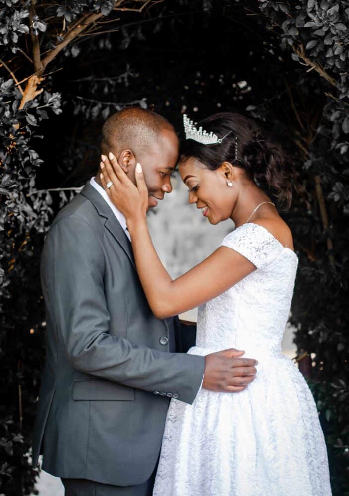 Free Man in Gray Suit Dancing with Woman in White Dress Stock Photo