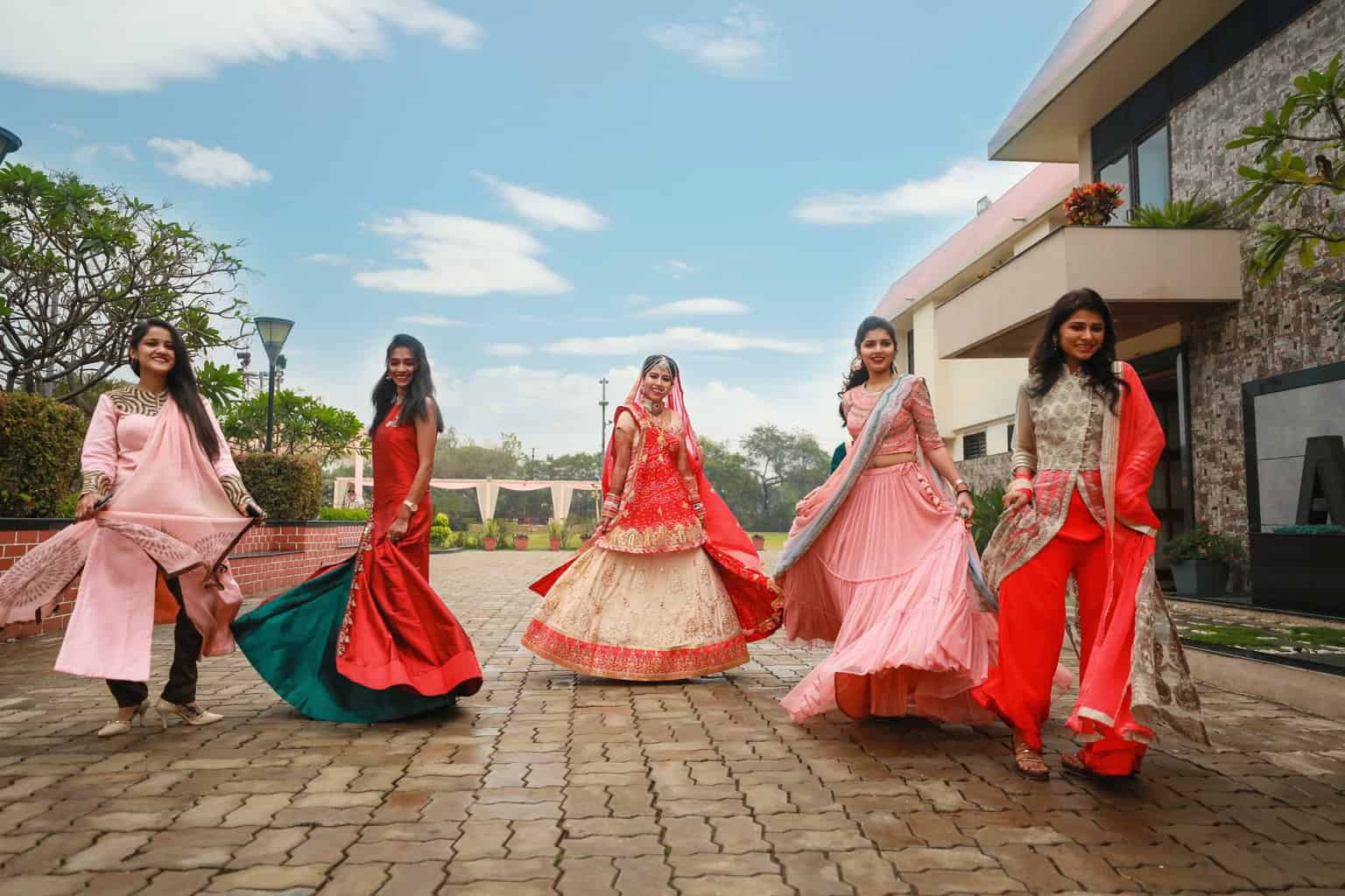 five women wearing red dress standing on pavement