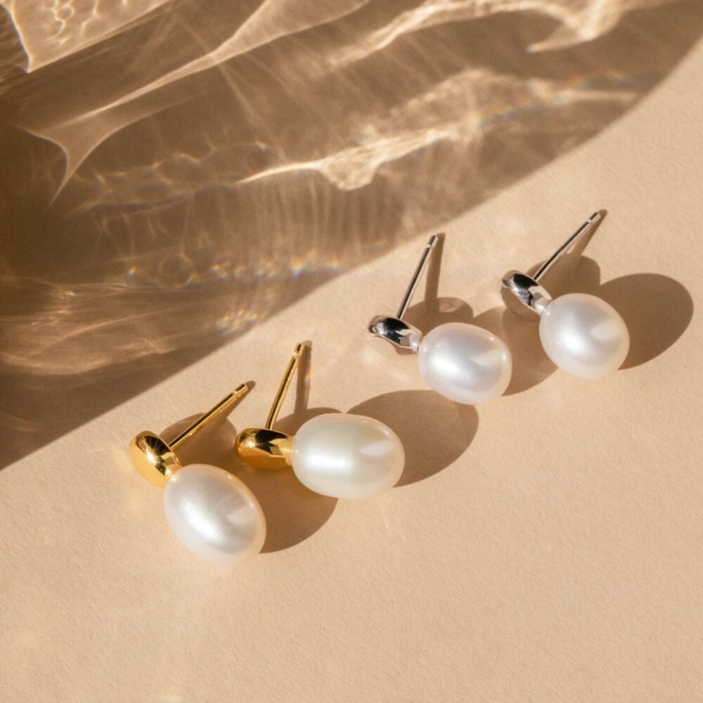 three pairs of earrings sitting on top of a table